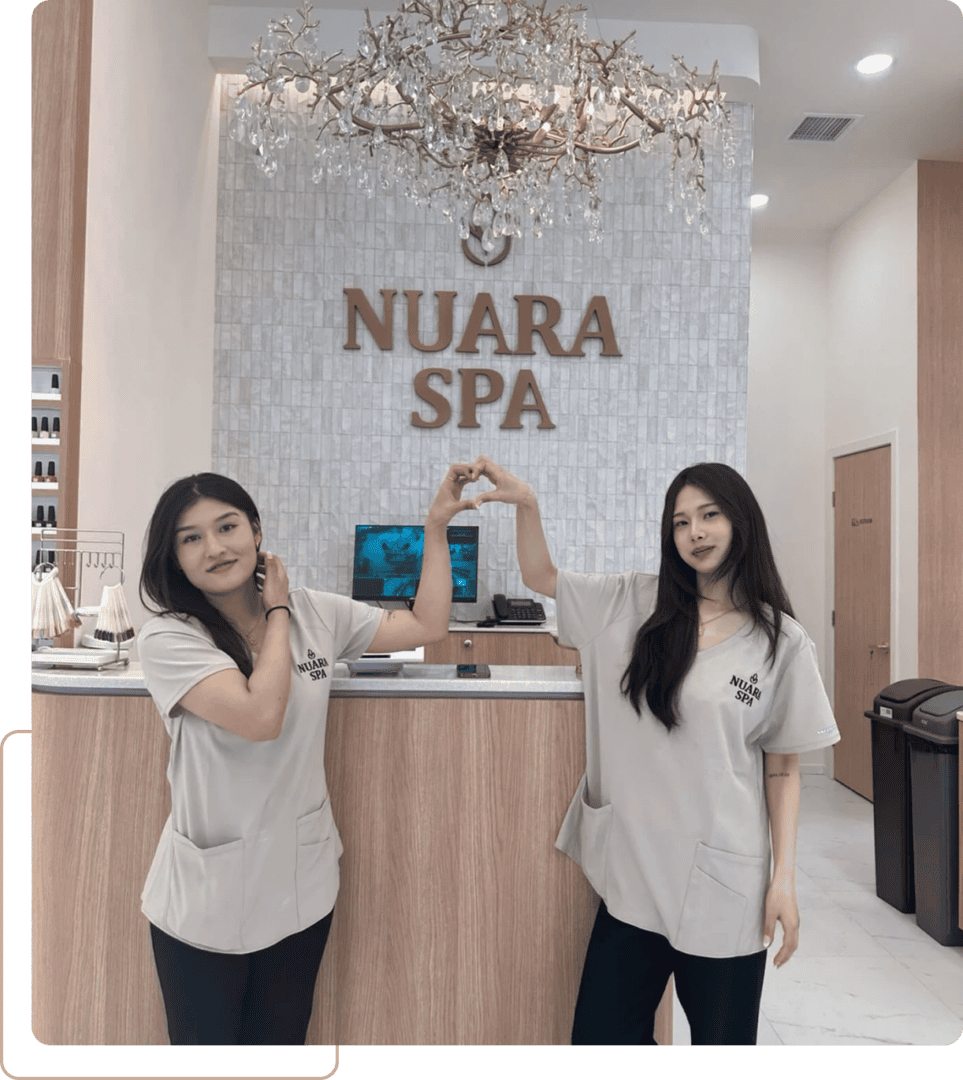 Two spa staff forming heart at Nuara Spa