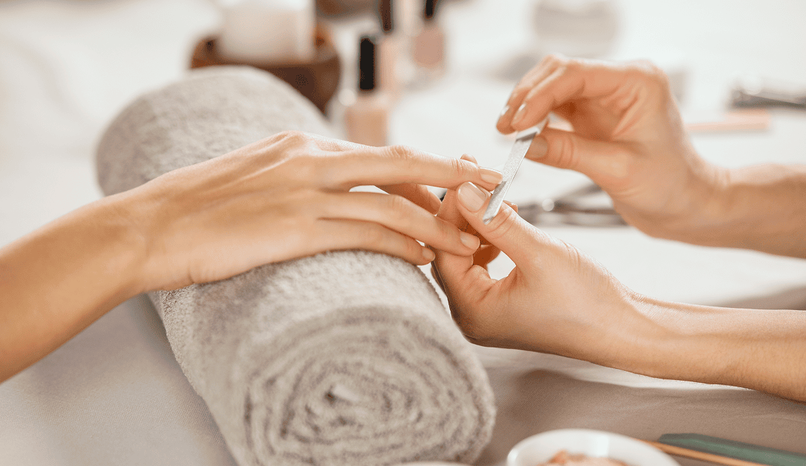 Manicure session with nail filing