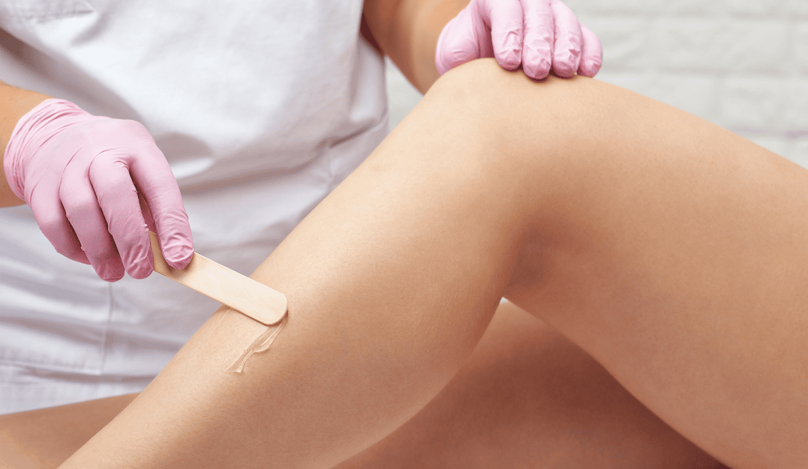 Leg waxing process with wooden spatula